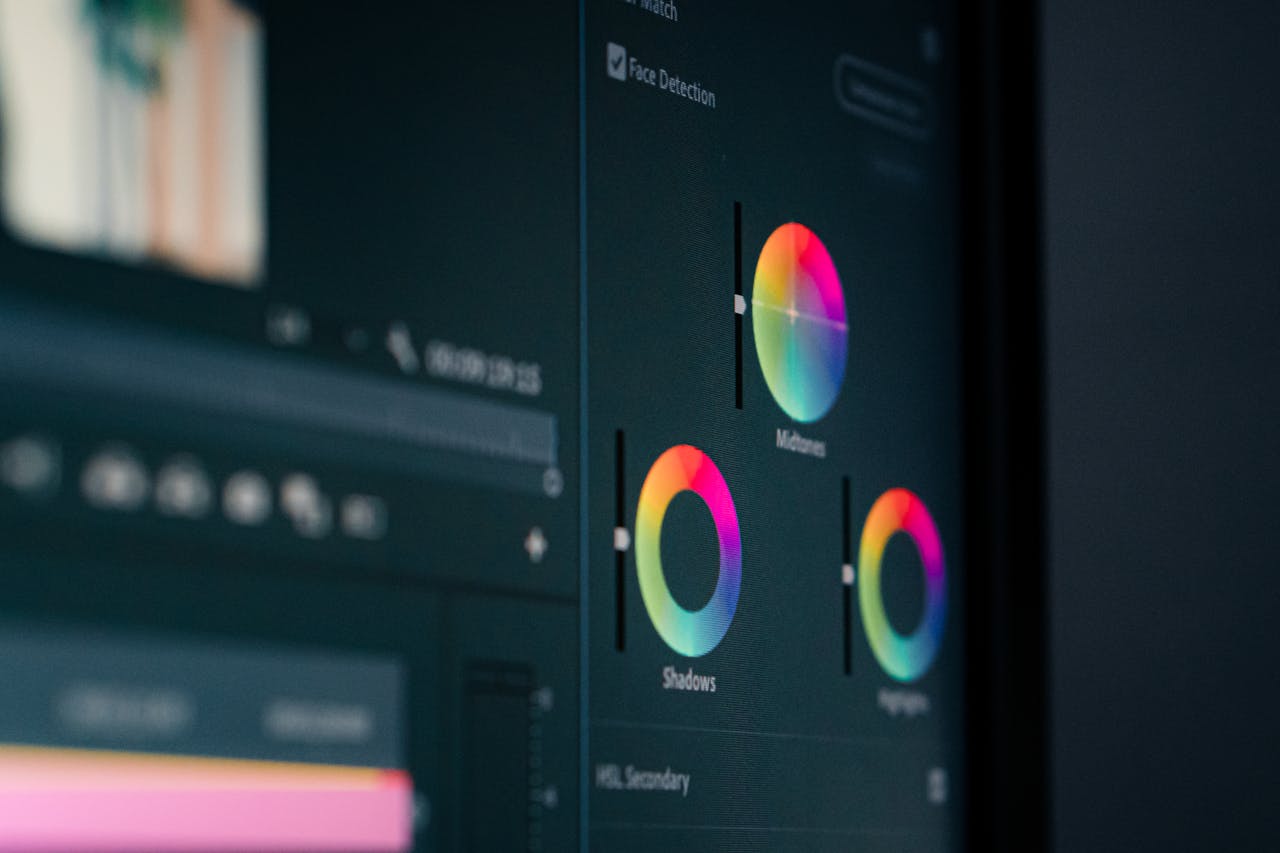 journey-01 Close-up of color grading wheels on a monitor, showcasing digital editing in vibrant hues.